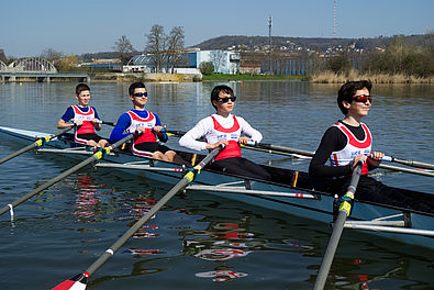 Young people practice rowing