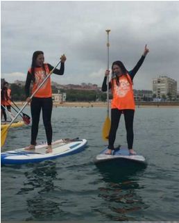 Young beginners practicing SUP